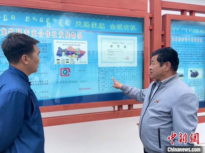 图为河南县农牧水利和科技局农办项目办主任才让南杰(右)介绍合作社情况。　祁绣娟 摄