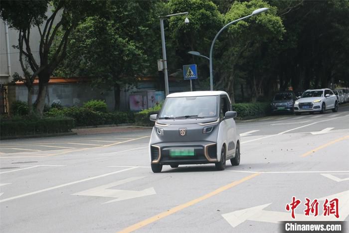 6月23日 ，一辆新潮小巧的新能源汽车在广西柳州市街头飞驰而过。目前，柳州市已形成“十分钟充电圈”用车生态，累计建成各类充电设施2.8万个、充电站点1330个，充电设施数量和密度超过加油站。 中新社记者 林馨 摄