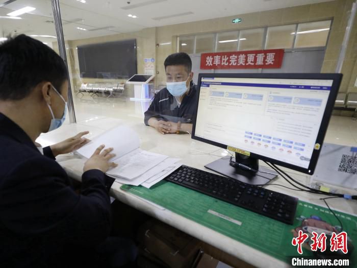 河北廊坊固安县市民服务中心审批业务大厅，工作人员为一家企业办理相关审批手续。　门丛硕 摄