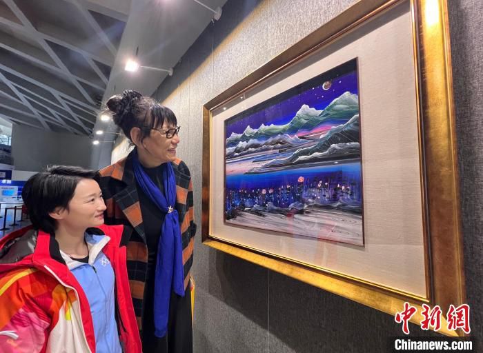 著名体育明星郑海霞(左二)、吴静钰在活动现场一起观看黄建南的油画作品。　潘旭临 摄