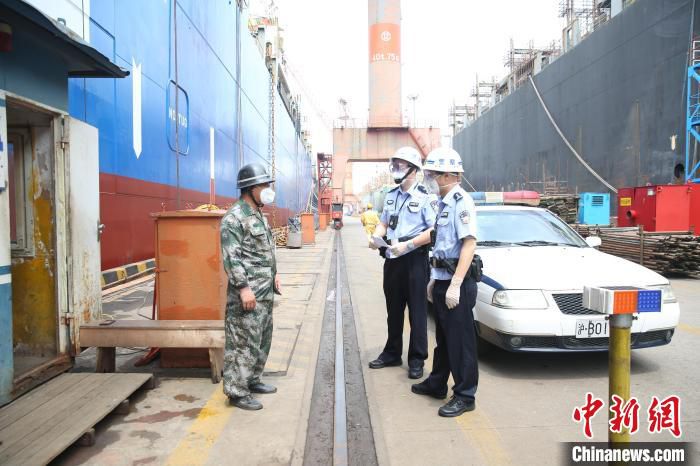 边检民警在码头现场听取企业工人意见建议。　崇明边检站供图